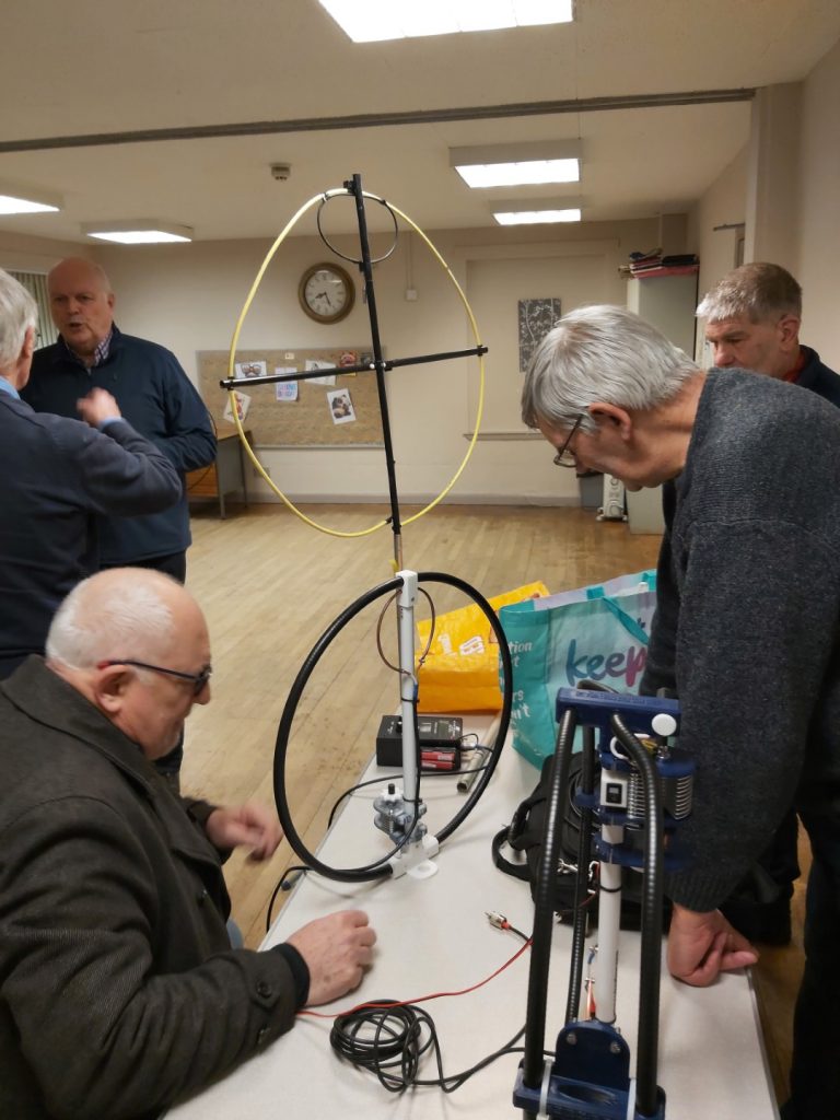 Looking at several magnetic loop antennas on the table and on tripod